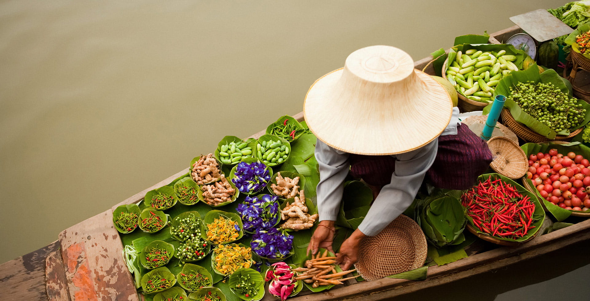 Asian woman selling food on a boat